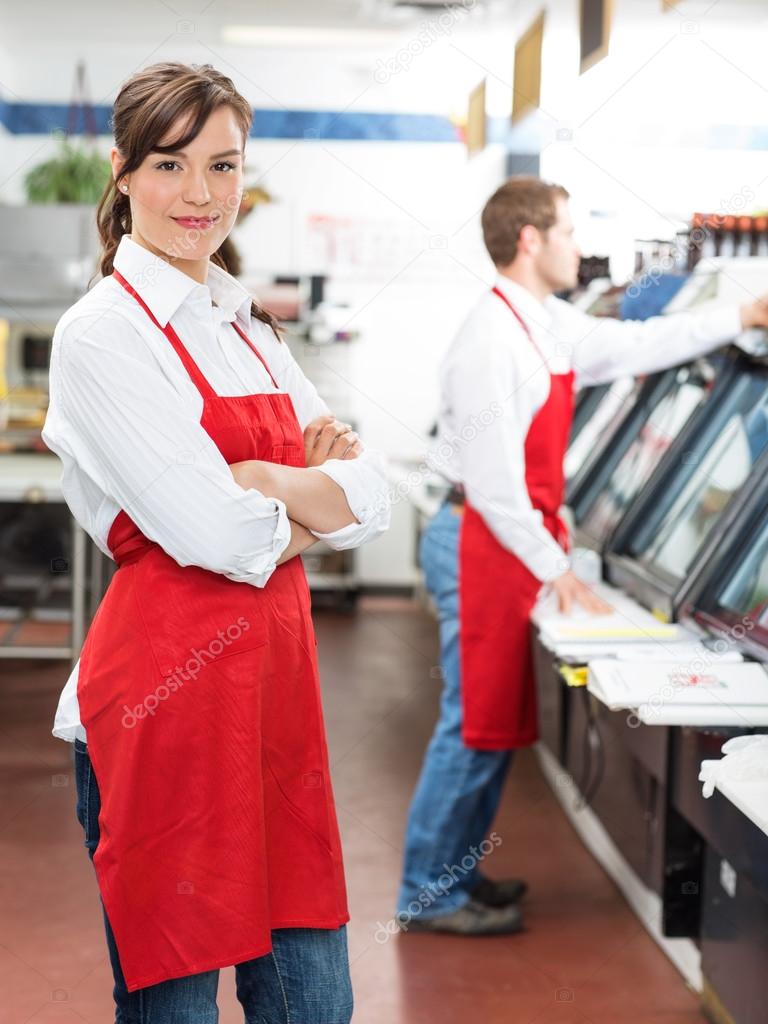 Female Butcher Standing Arms Crossed At Store