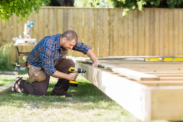 Carpenter Drilling Wood At Construction Site — Stock Photo, Image