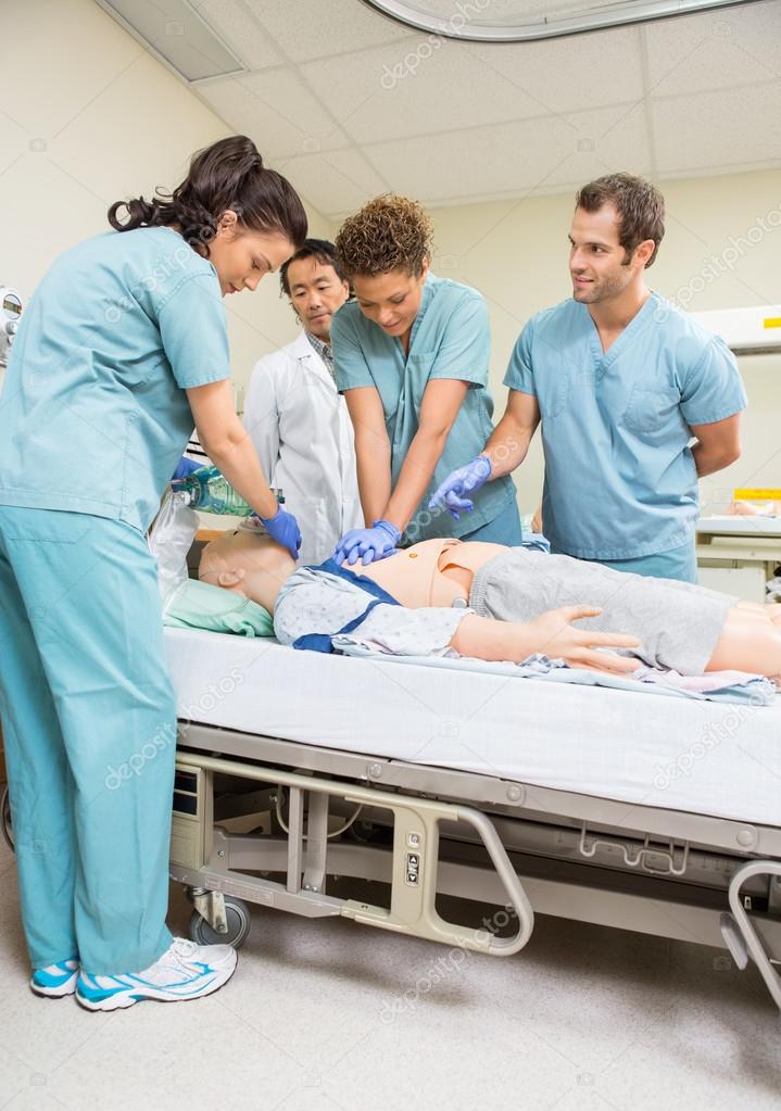 Medical Team Performing CPR On Dummy Patient Stock Photo by ©SimpleFoto
