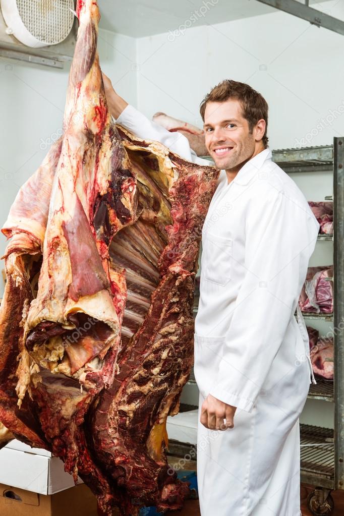 Butcher Standing in Cooler with Beef