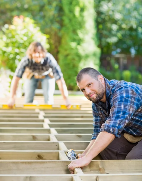 Carpenter Holding Drill At Building Site — Stock Photo, Image