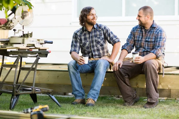 Carpenters Holding Disposable Coffee Cups On Wooden Frame At Sit — Stock Photo, Image