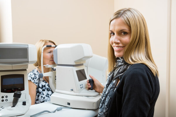 Optometrist Using Tonometer to Measure Patients Eye Pressure