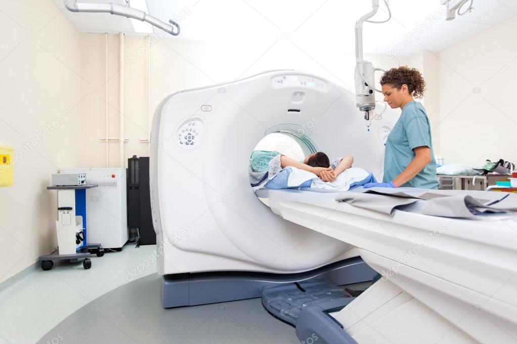 Nurse Preparing Patient For CT Scan Test