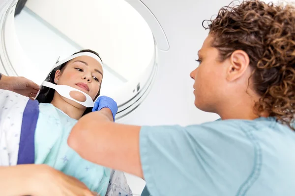 Patient Looking At Nurse Adjusting Strap Before CT Scan — Stock Photo, Image