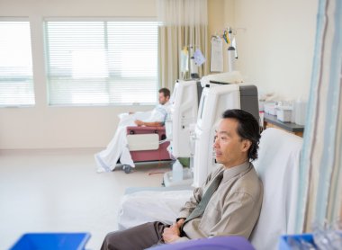 Man Waiting For Renal Dialysis Treatment In Hospital clipart