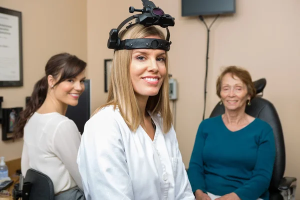 Optometristen met senior patiënt in winkel — Stockfoto
