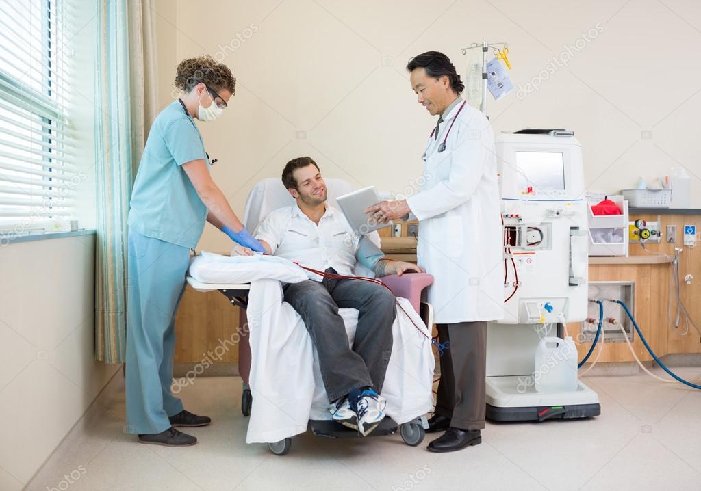 Doctor Showing Digital Chart to Dialysis Patient