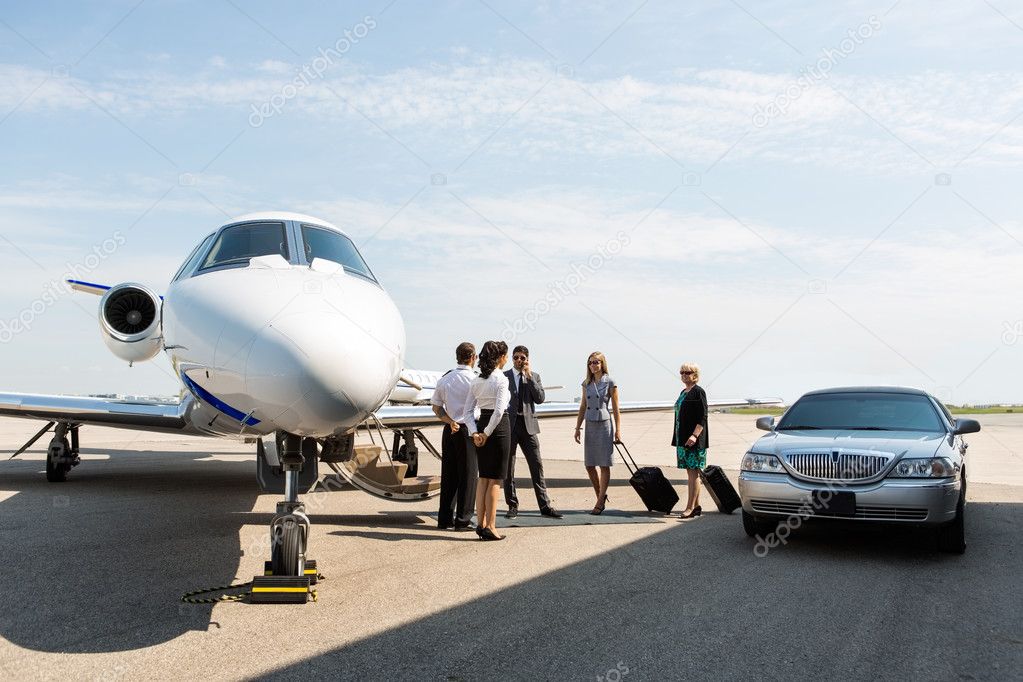 Business People With Pilot And Airhostess At Terminal