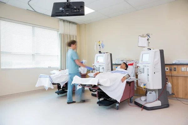 Nurse Walking By Patient Receiving Renal Dialysis — Stock Photo, Image