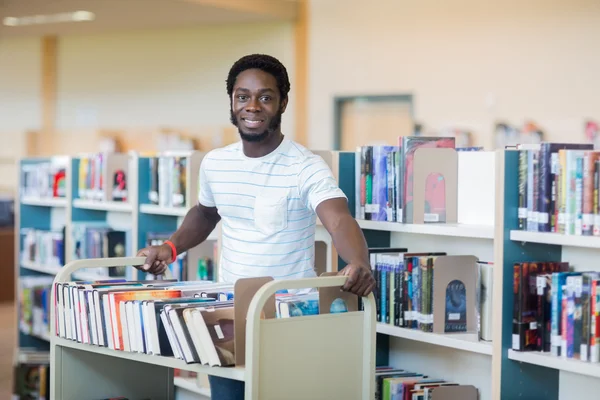 Librarian With Trolley Of Books In Library — Stock Photo, Image