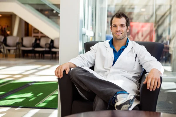 Confident Male Doctor Sitting On Chair — Stock Photo, Image