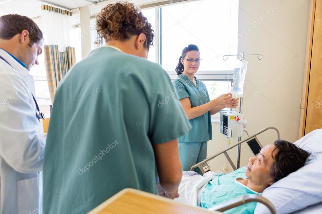 Medical Team Examining Patient In Hospital