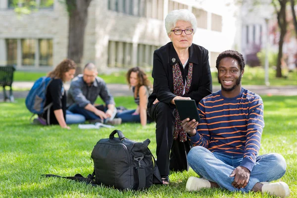 Professor Helping Student on Digital Tablet — Stock Photo, Image