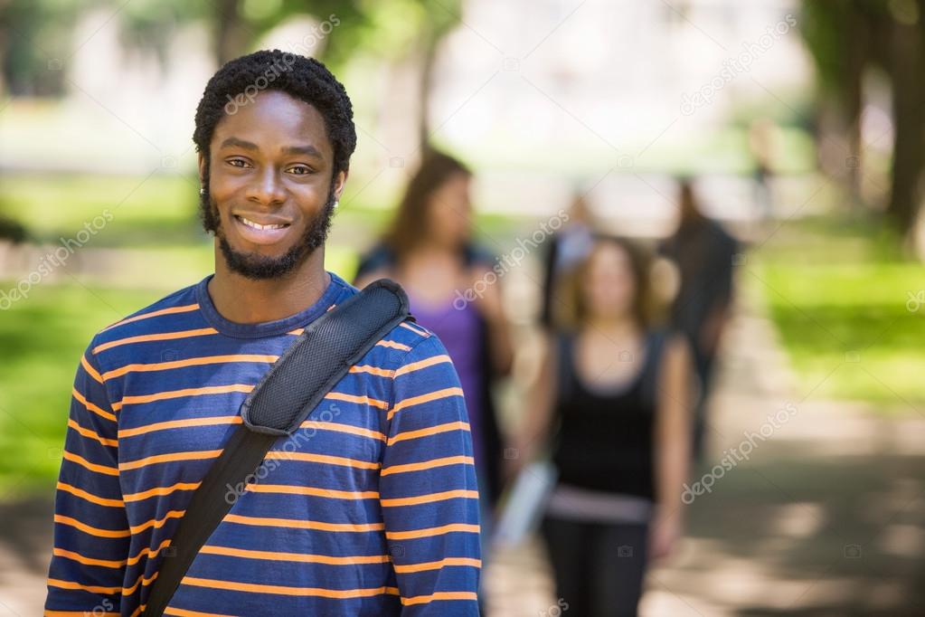 Young Male Grad Student Smiling On Campus