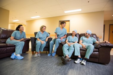 Medical Team Conversing In Hospital's Waiting Room
