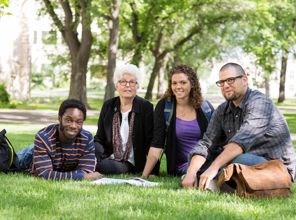 Students Sitting On Grass At Campus Park — Stock Photo, Image