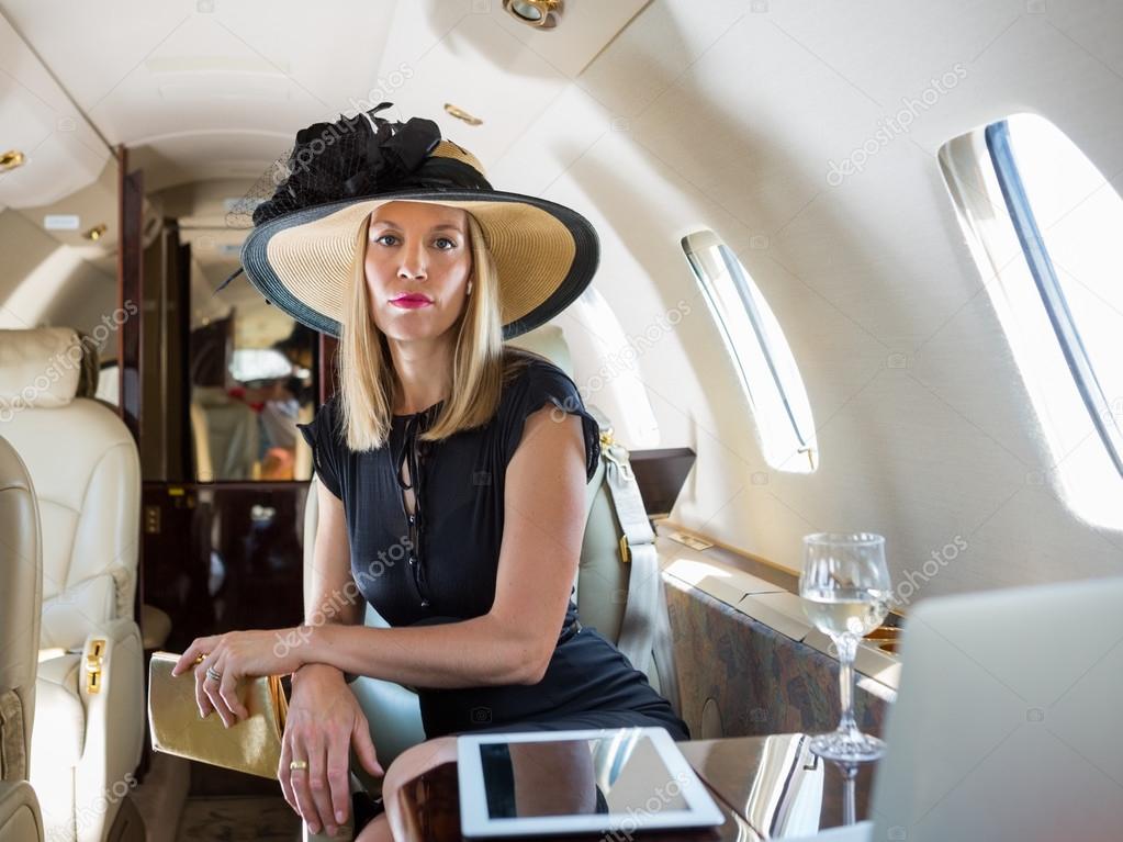 Rich Woman Sitting In Private Jet