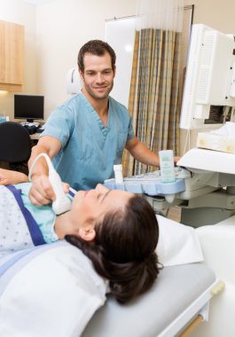 Nurse Performing Ultrasound On Patient's Neck clipart