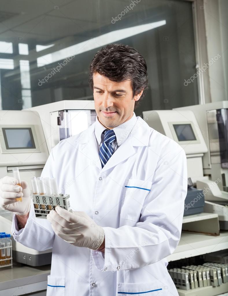 Technician Analyzing Urine Samples In Laboratory