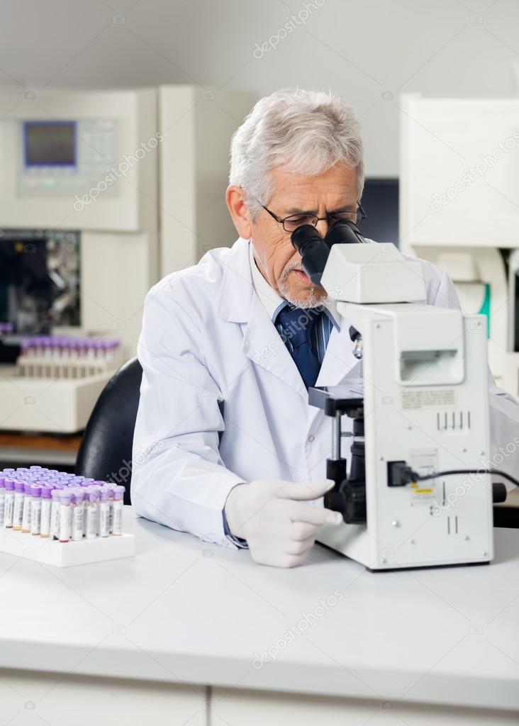 Male Scientist Using Microscope In Lab