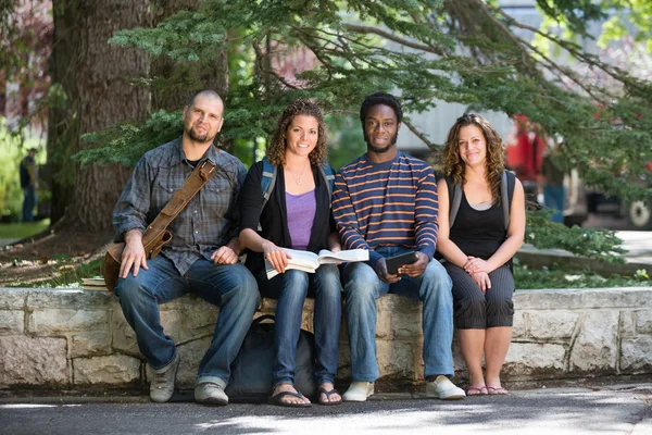 Portrait Of University Students Sitting On Campus — Stock Photo, Image