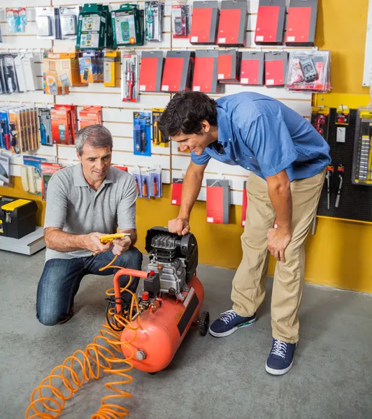 Family Examining Air Compressor In Store — Stock Photo, Image