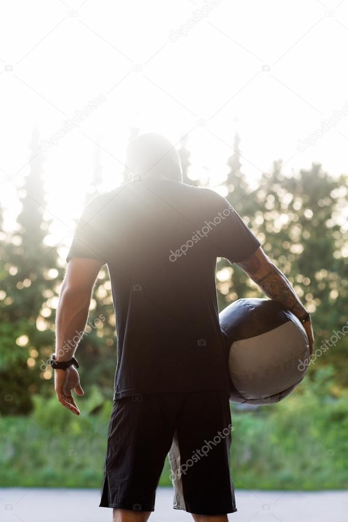 Fit Man Carrying Medicine Ball