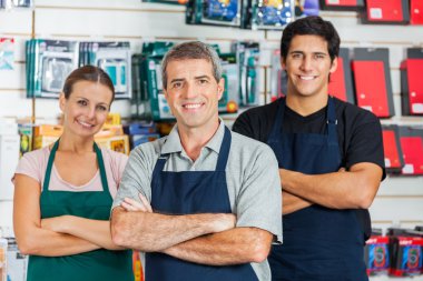 Salespeople Standing Arms Crossed In Hardware Shop clipart