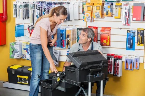 Verkäufer führt Kunden bei der Auswahl von Werkzeugen im Geschäft — Stockfoto