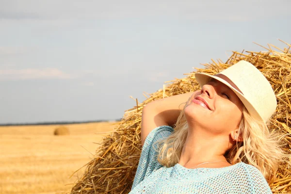 Beautiful woman near haystack — Stock Photo, Image