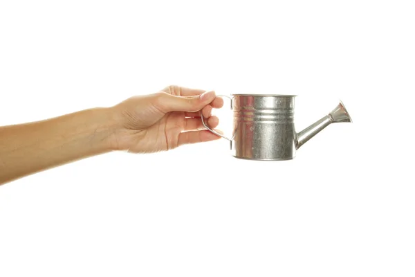 Woman hand with a steel watering can — Stock Photo, Image