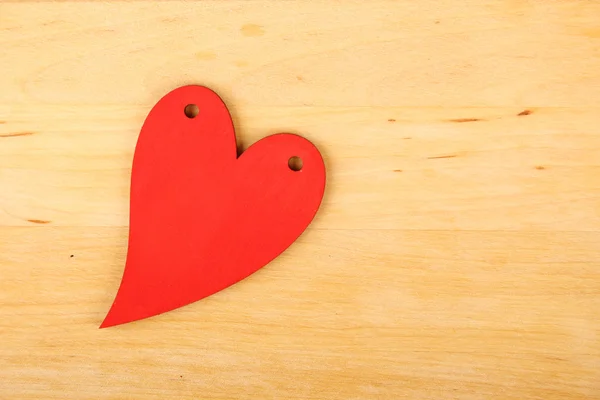 Corazón sobre fondo de madera — Foto de Stock