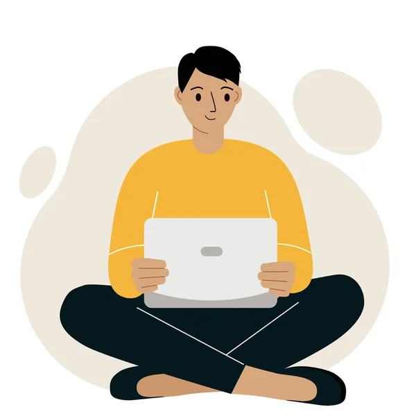 Un uomo o un ragazzo si siede e lavora in un computer portatile. Lavoro a distanza o comunicazione via Internet. Soddisfatto, gioioso. — Vettoriale Stock