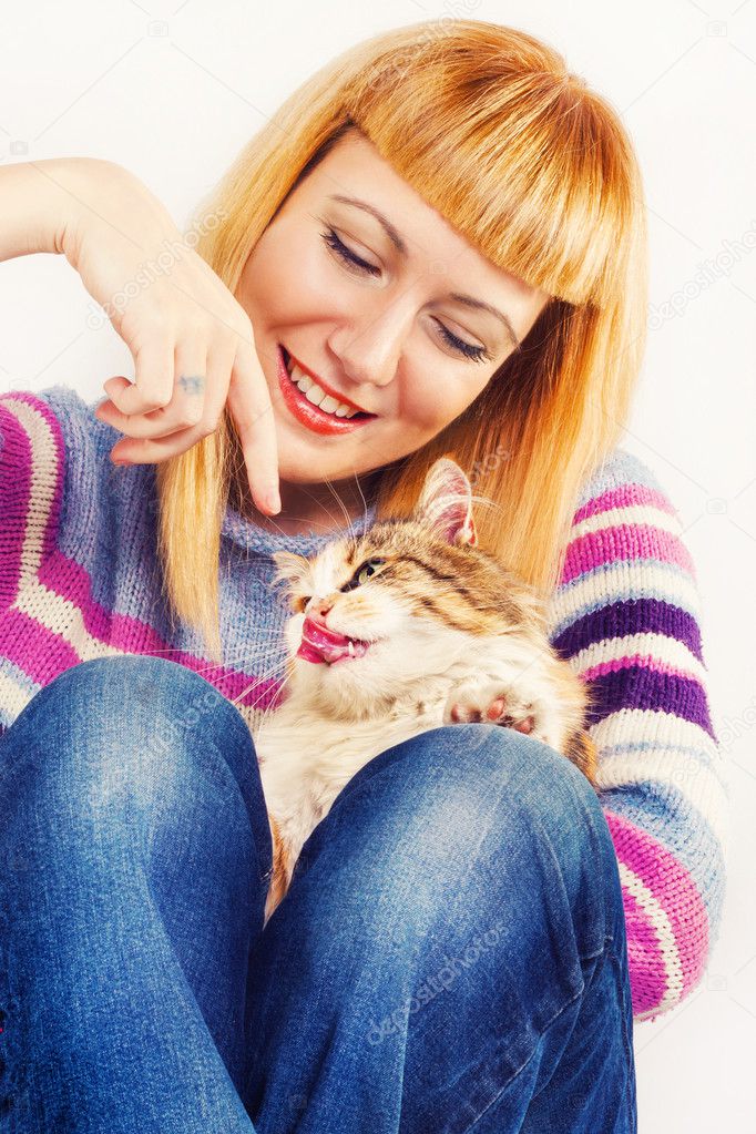 Blond woman playing with a cat