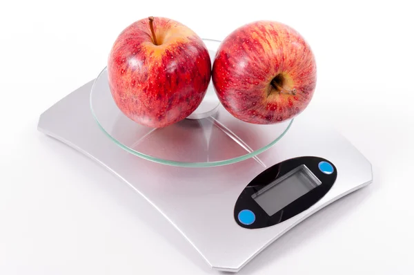 Red apple on kitchen scale — Stock Photo, Image