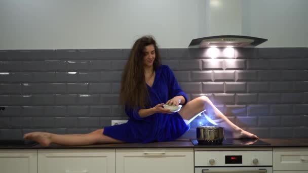 Mujer atractiva, flexible y seductora cocinando en la cocina. Concepto de yoga y estilo de vida saludable — Vídeo de stock