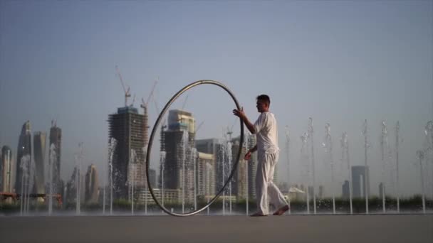Cyr Wheel Artist Wearing White Arabic Clothing Cloth Dubai Cityscape — Stockvideo