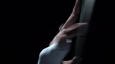 Muscular circus artist perform Cyr Wheel on a black background.Concept of Individuality and creativity .