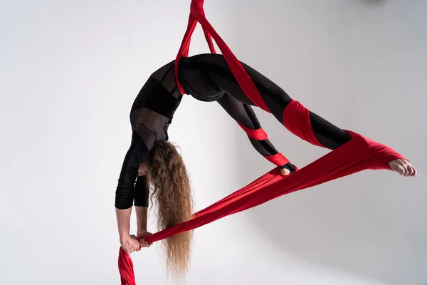 Flexible Female Flying Yoga Artist Performs Aerial Silk White Background — Foto Stock