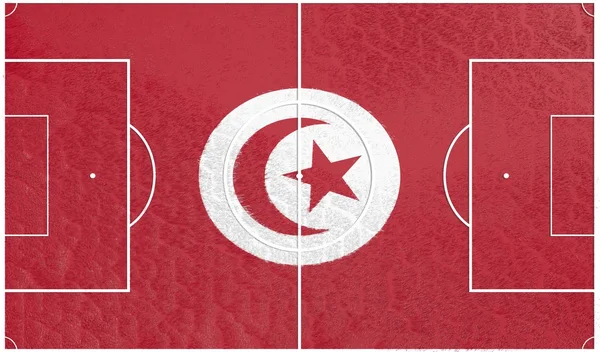 Tunisien flagga på fotbollsplan — Stockfoto