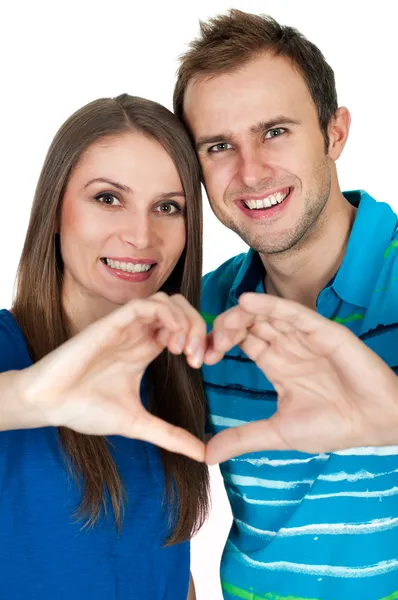 Young couple making heart gesture of love Royalty Free Stock Images