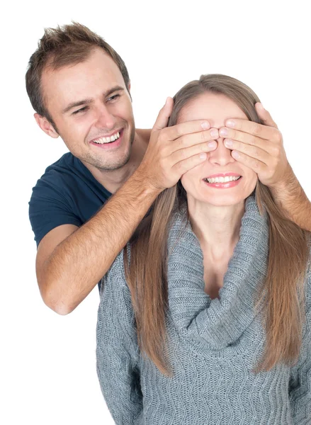 Man covering her lover's eyes making surprise. Stock Image