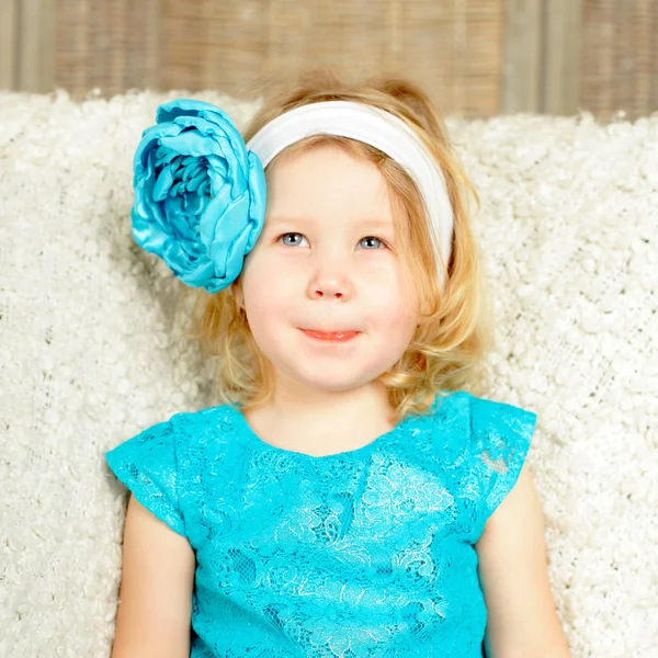 Curious smiling child girl with blue flower — Stock Photo, Image