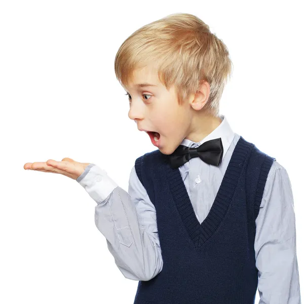 Surprised boy showing something and looking at hand — Stock Photo, Image