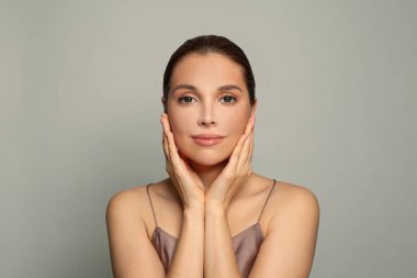 Facial treatment, skin care and beauty concept. Perfect young woman face with clear healthy skin