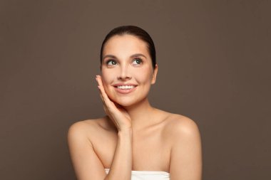 Perfect young woman spa model portrait on brown background