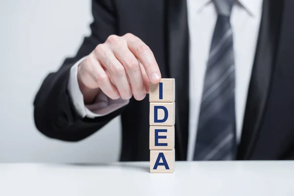 Businessman Holding Cube Idea Inscription —  Fotos de Stock