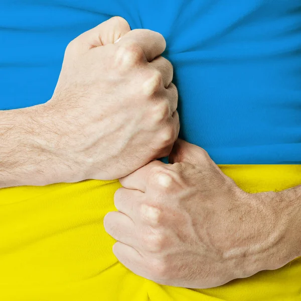 Help Ukraine concept. Strong man hands on Ukrainian flag background