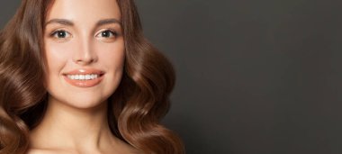 Attractive woman face. Cute model smiling on black banner background